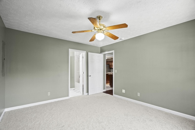 unfurnished bedroom featuring carpet, ceiling fan, a textured ceiling, and connected bathroom