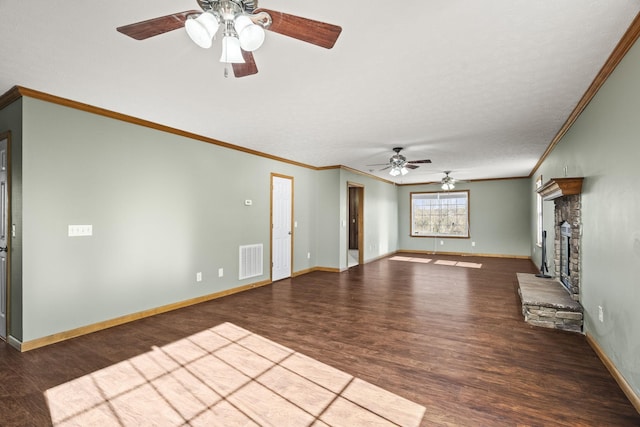 unfurnished living room featuring dark hardwood / wood-style flooring, a stone fireplace, ceiling fan, and crown molding