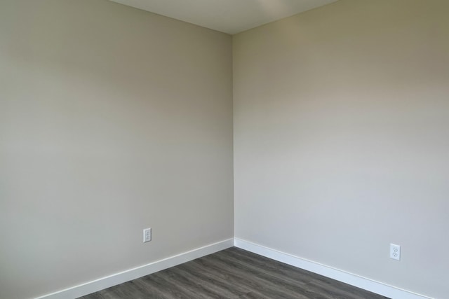 unfurnished room featuring dark hardwood / wood-style flooring