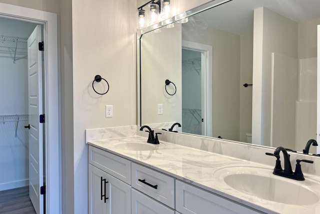 bathroom with vanity, toilet, and wood-type flooring