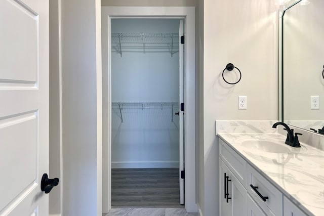 bathroom with hardwood / wood-style floors and vanity