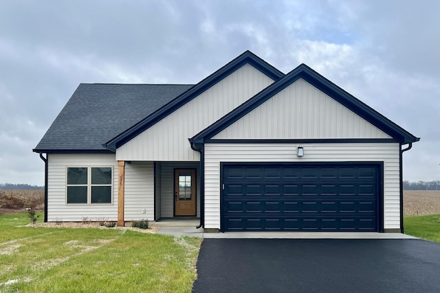 view of front of property with a front yard and a garage