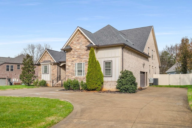 view of front of house featuring a garage and central air condition unit