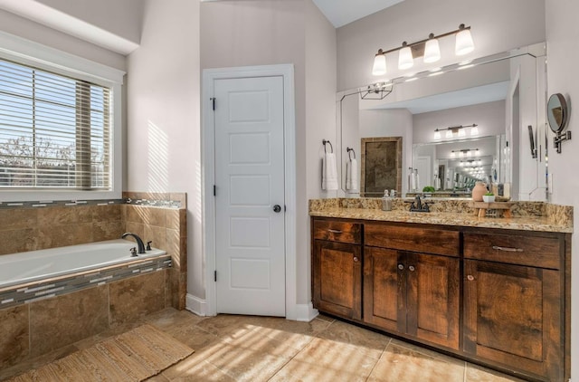 bathroom featuring vanity, tiled bath, and tile patterned floors