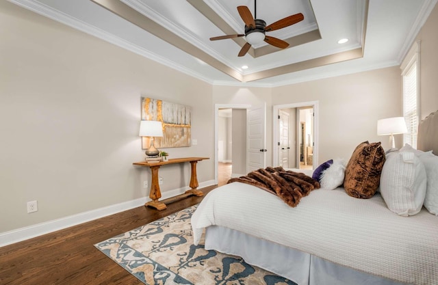 bedroom featuring dark hardwood / wood-style floors, a raised ceiling, ceiling fan, and ornamental molding