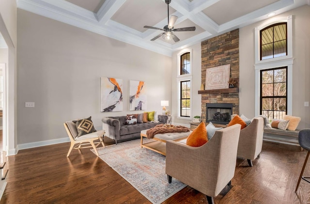 living room with a fireplace, ceiling fan, dark wood-type flooring, and coffered ceiling