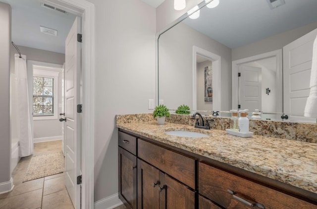 bathroom featuring shower / bathtub combination with curtain, tile patterned flooring, and vanity