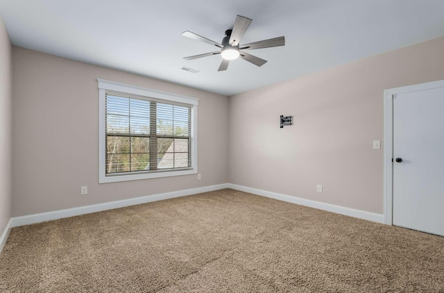 spare room featuring carpet flooring and ceiling fan