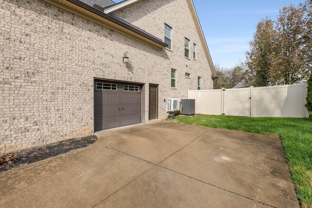 view of home's exterior with a garage and central air condition unit