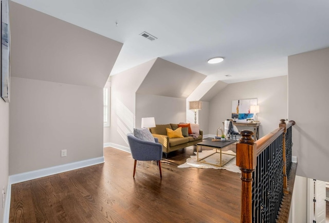 living area with hardwood / wood-style floors and vaulted ceiling