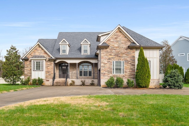 view of front of house with a front yard and a porch