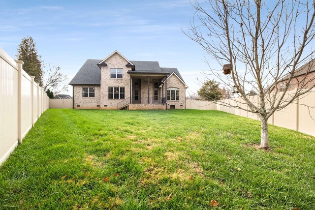 rear view of house with a yard