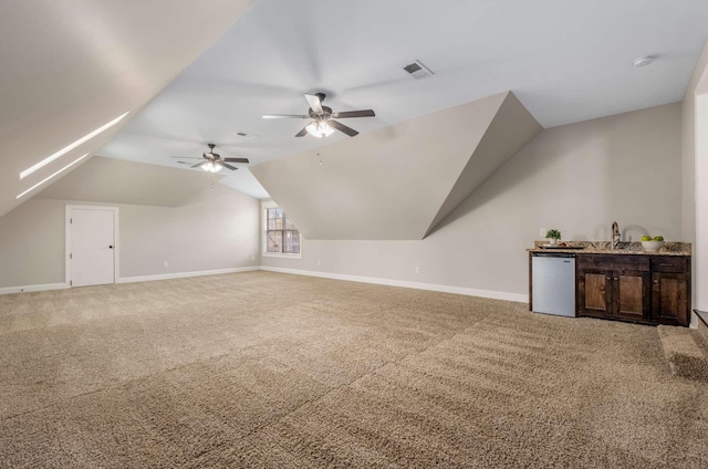 bonus room with ceiling fan, carpet floors, and vaulted ceiling