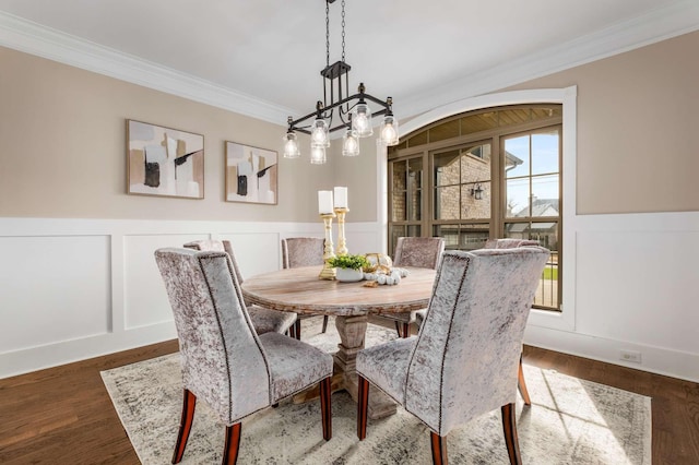 dining room featuring ornamental molding and dark wood-type flooring