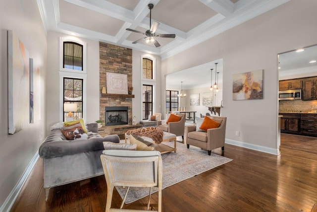 living room with a fireplace, plenty of natural light, dark hardwood / wood-style floors, and coffered ceiling