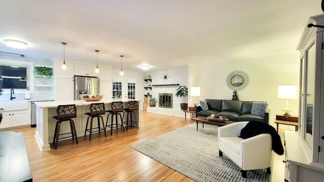 living room featuring light hardwood / wood-style floors and a fireplace