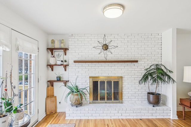 unfurnished living room featuring a fireplace and light hardwood / wood-style flooring