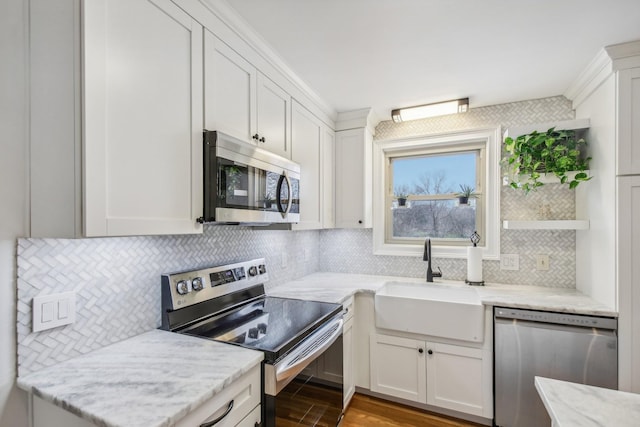 kitchen featuring sink, white cabinets, wood-type flooring, and appliances with stainless steel finishes