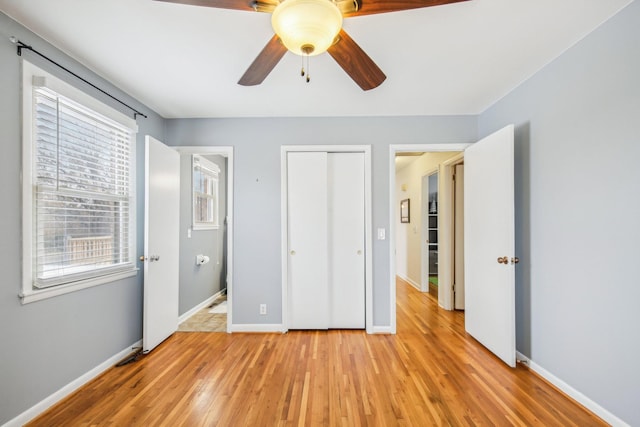 unfurnished bedroom featuring light wood-type flooring and ceiling fan