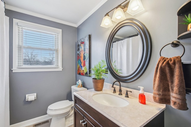 bathroom with crown molding, vanity, a healthy amount of sunlight, and toilet