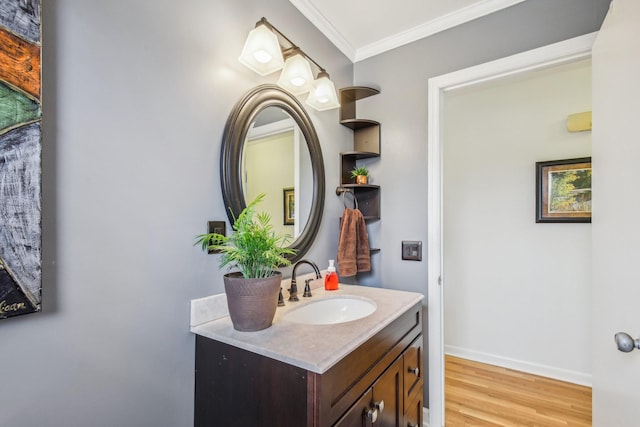 bathroom with vanity, wood-type flooring, and ornamental molding