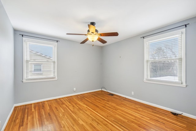 unfurnished room featuring light hardwood / wood-style flooring, a wealth of natural light, and ceiling fan