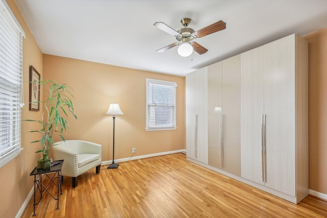 sitting room with light hardwood / wood-style flooring and ceiling fan