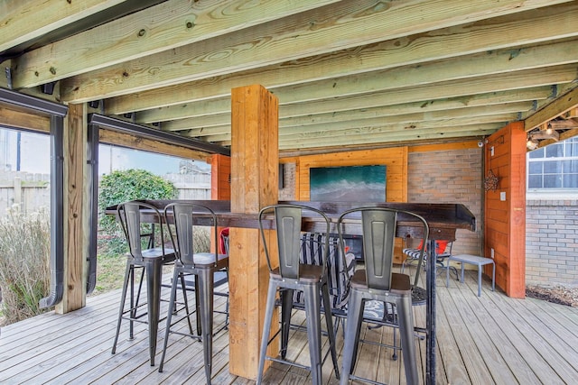 wooden terrace featuring a bar