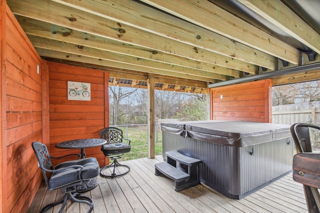 wooden deck with a hot tub