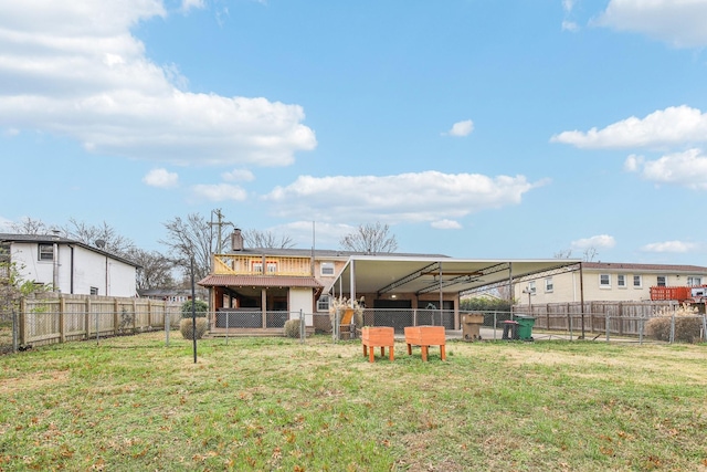 rear view of property featuring a lawn