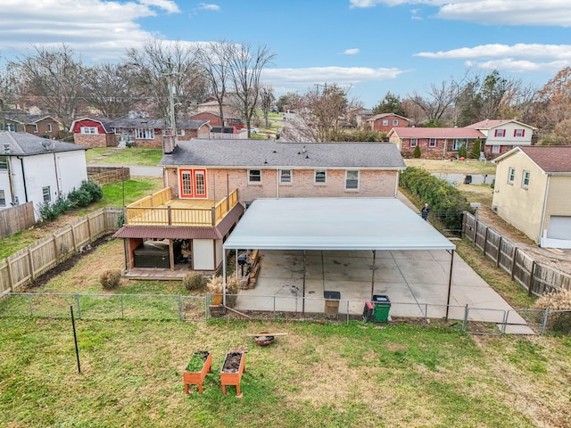 rear view of property with a lawn and a wooden deck