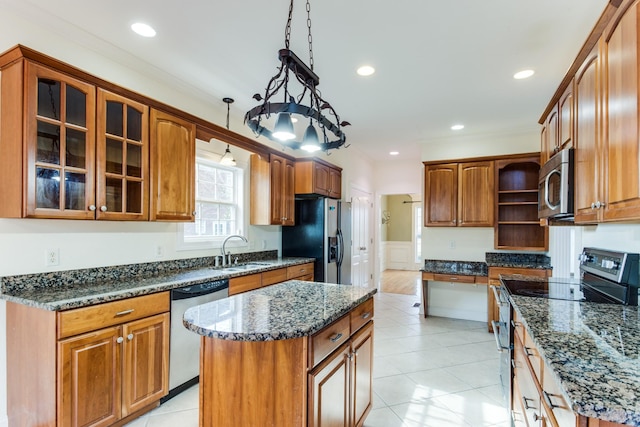 kitchen with appliances with stainless steel finishes, ornamental molding, sink, decorative light fixtures, and a kitchen island