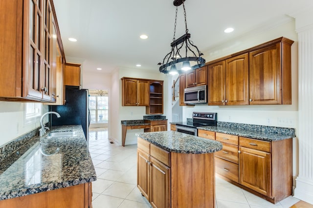 kitchen with a center island, dark stone counters, sink, decorative light fixtures, and stainless steel appliances