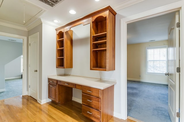 unfurnished office featuring light carpet and crown molding