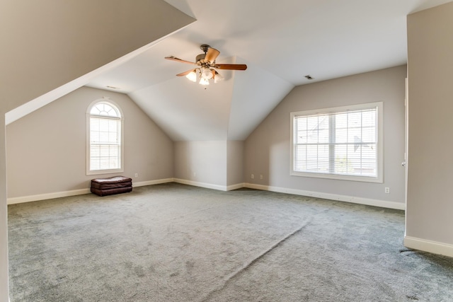 additional living space featuring ceiling fan, lofted ceiling, and carpet floors