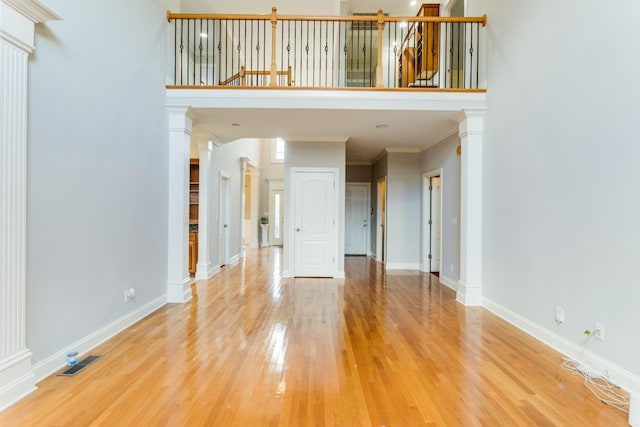 empty room featuring wood-type flooring and crown molding