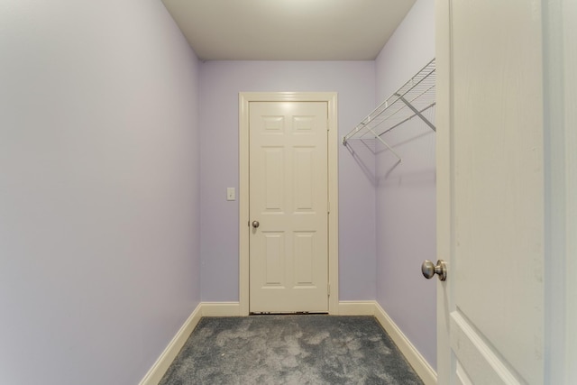 laundry area featuring dark carpet