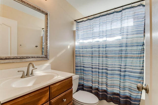 full bathroom with shower / tub combo with curtain, vanity, and toilet