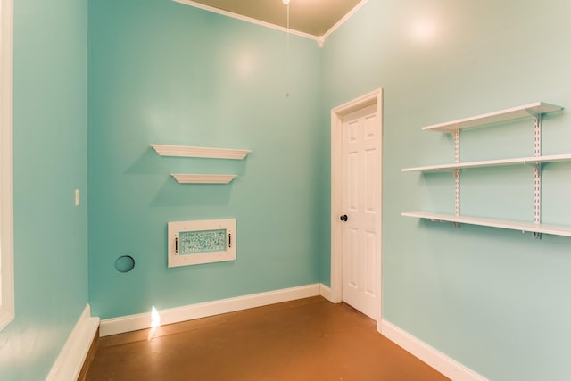 unfurnished room featuring concrete flooring and crown molding