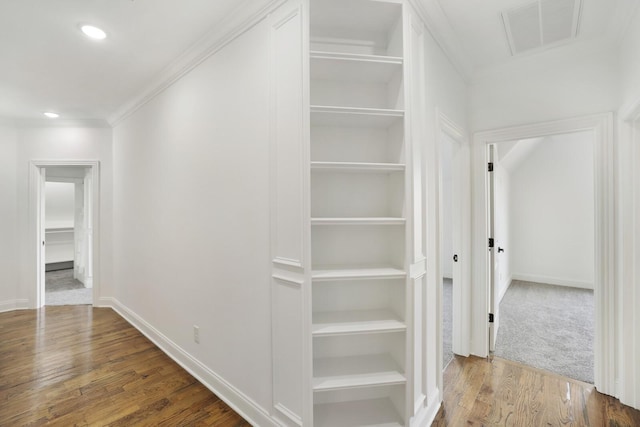 corridor featuring hardwood / wood-style flooring and ornamental molding