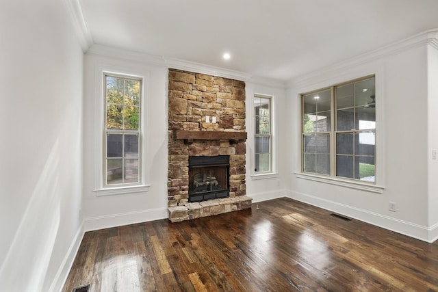 unfurnished living room featuring plenty of natural light, dark hardwood / wood-style flooring, and ornamental molding