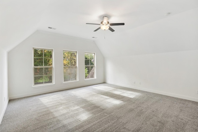 additional living space featuring ceiling fan, light colored carpet, and lofted ceiling