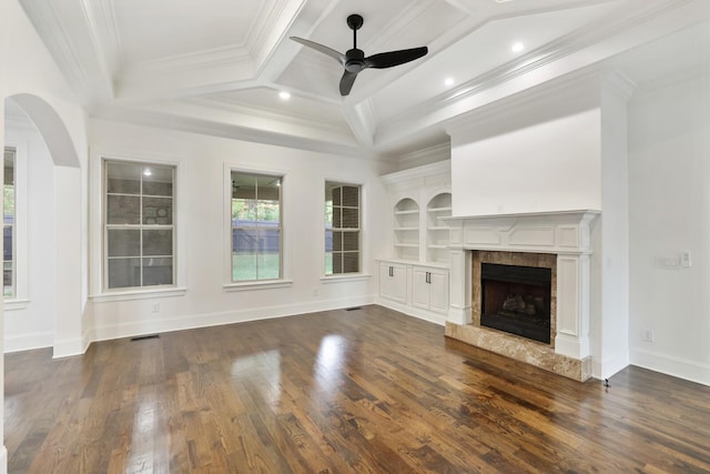 unfurnished living room featuring coffered ceiling, crown molding, a fireplace, and dark hardwood / wood-style floors