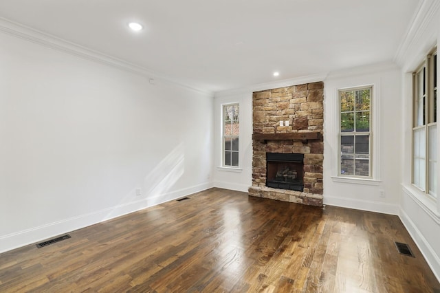 unfurnished living room with dark hardwood / wood-style floors, a healthy amount of sunlight, ornamental molding, and a fireplace