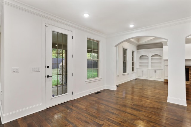 interior space with dark hardwood / wood-style flooring and ornamental molding