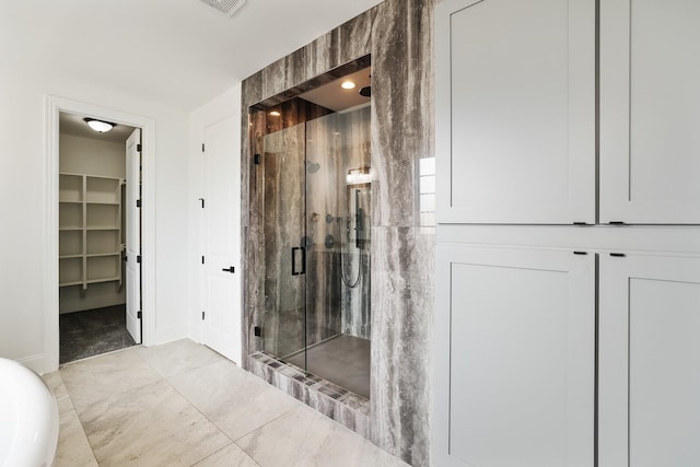 bathroom with tile patterned floors and a shower with shower door