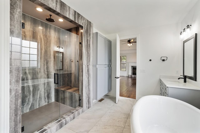 bathroom with ornamental molding, vanity, ceiling fan, independent shower and bath, and hardwood / wood-style floors