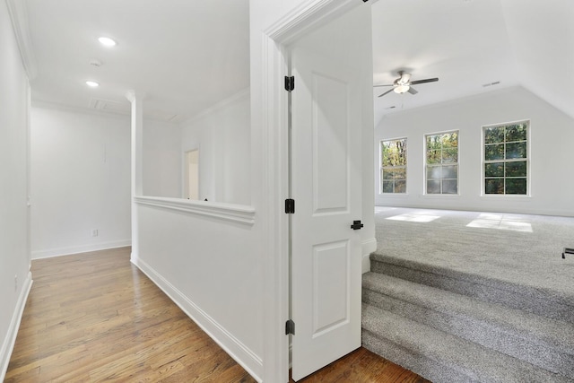 hall featuring hardwood / wood-style floors and vaulted ceiling