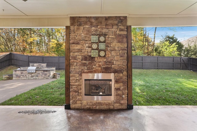 view of patio / terrace featuring an outdoor stone fireplace and exterior kitchen