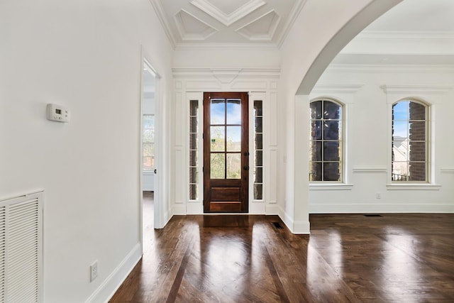 foyer entrance with crown molding and dark hardwood / wood-style floors